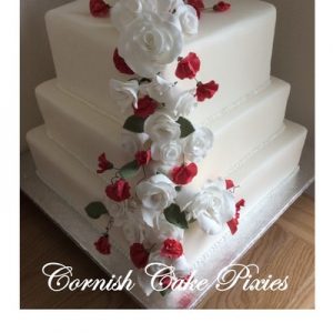 thee tier cake in white,white rose and pink sweet pea bouquet down on corner