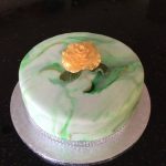 green and gold marbled cake (gin and lime) with golden rose decoration