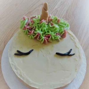 simple butter creamed cake with unicorn horn and piped mane.finished with closed eyes