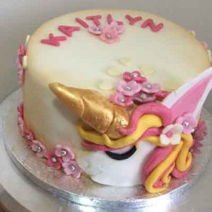 Unicorn head cake with flowers gold accents and name detail