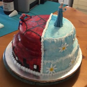 Half spider man,red with silhouette of sky line and half frozen themed cake, blue with icicles and white and yellow daisies