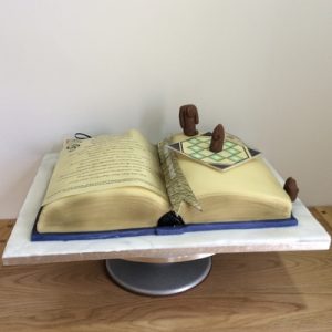 Terry Patchett Thud book cake with mini thud board and figures, side view