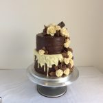 two tier chocolate cake white chocolate drizzle and chocolate roses
