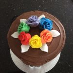 Rainbow cake in chocolate with rainbow roses