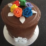 Rainbow cake in chocolate with rainbow roses